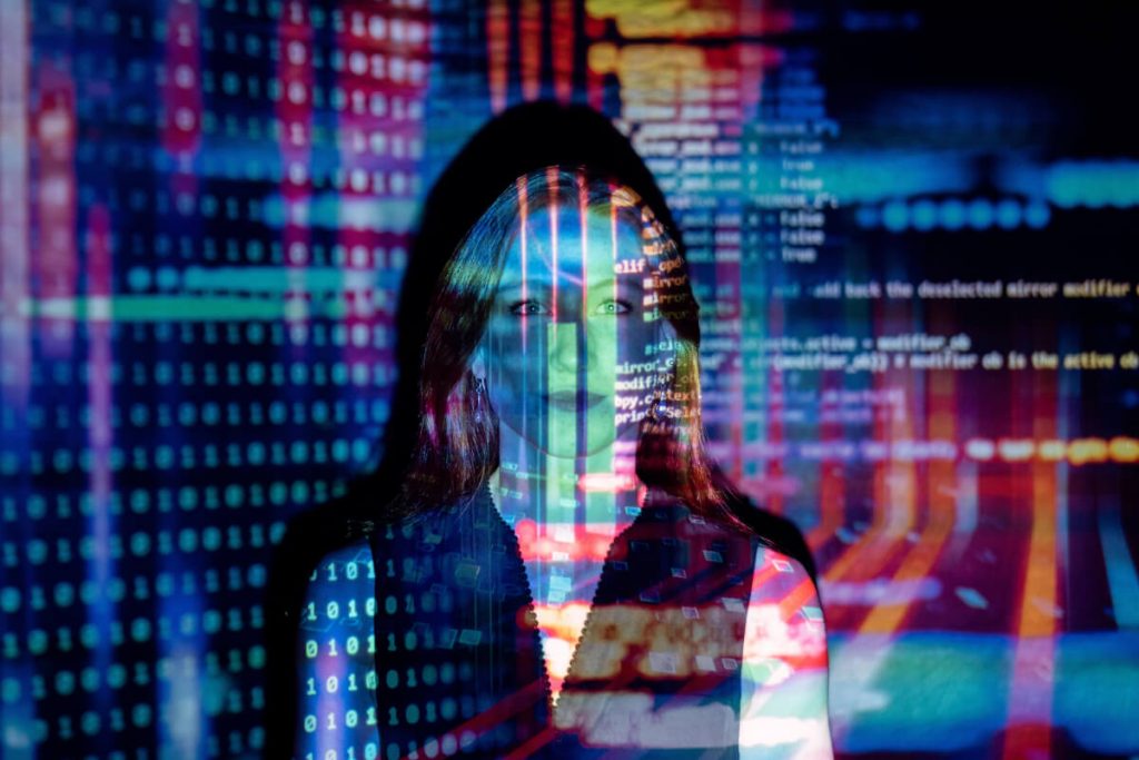 visual of computer code projected over woman's face